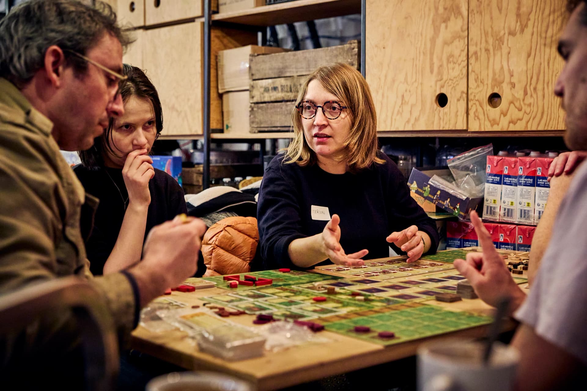 Personnes concentrées autour d’un plateau de jeu de société